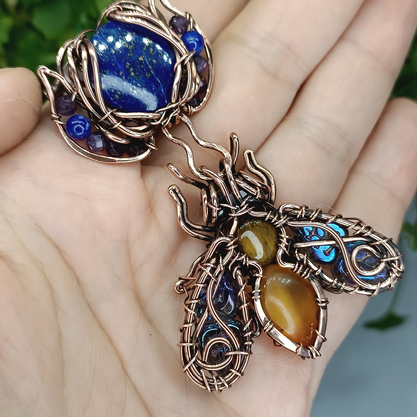 Blue winged bee pollinating on a flower. Pin/pendant.