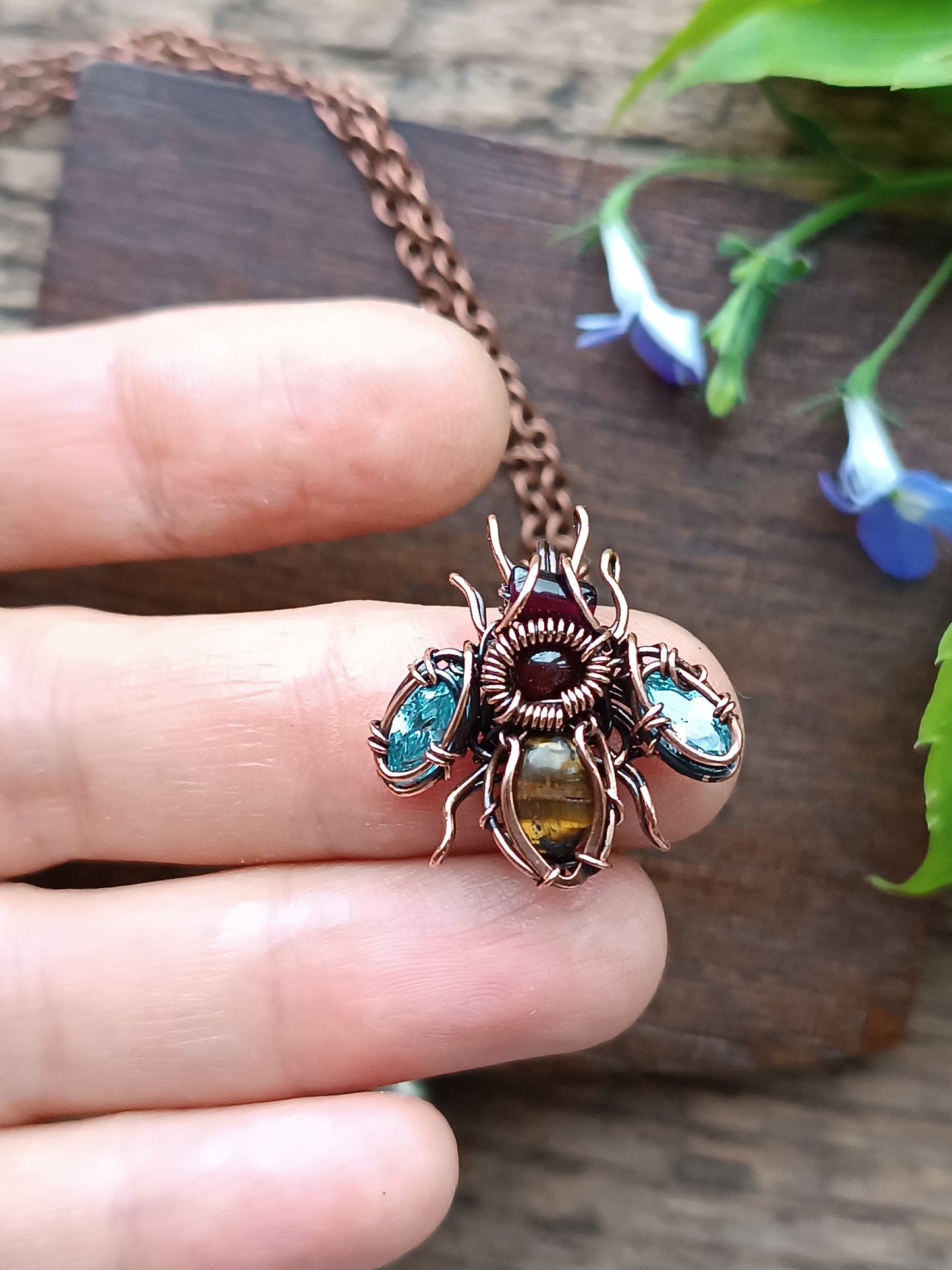 Tiny blue sparkle wings bee charm.
