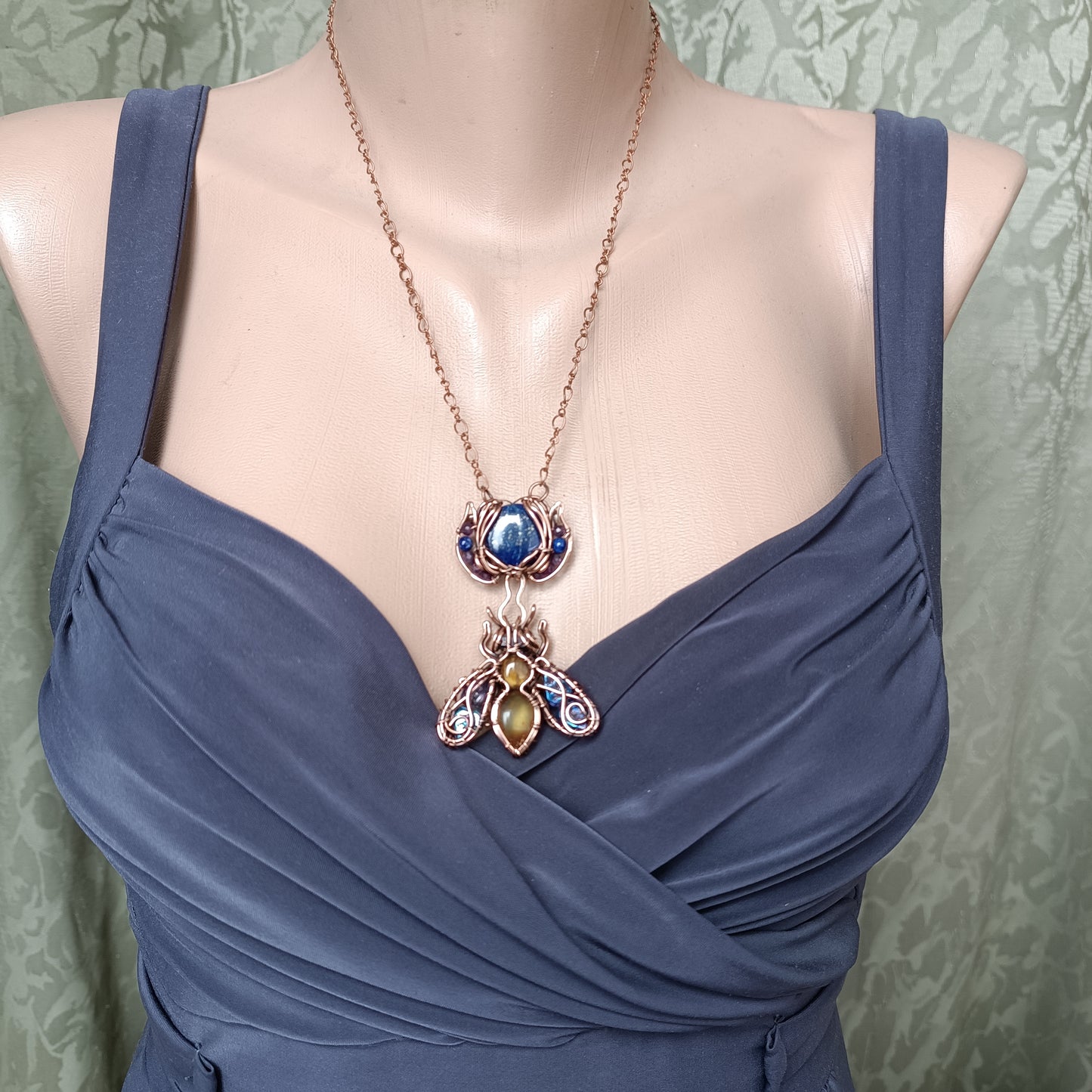 Blue winged bee pollinating on a flower. Pin/pendant.