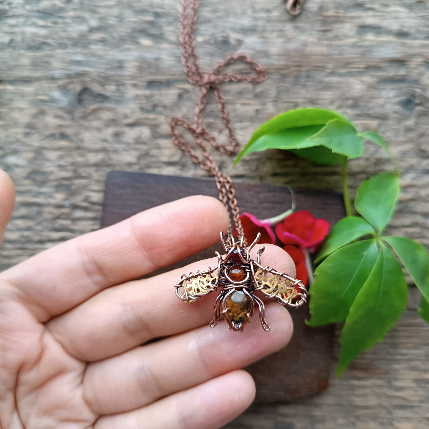 Small golden cogs wings bee charm.