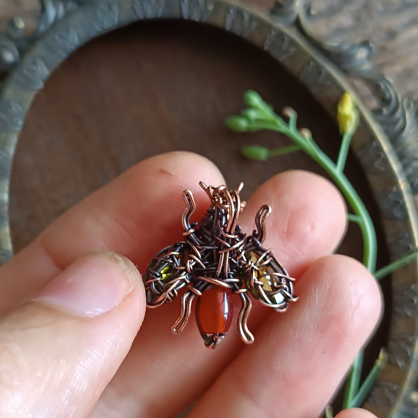 Green olive wings bee charm.