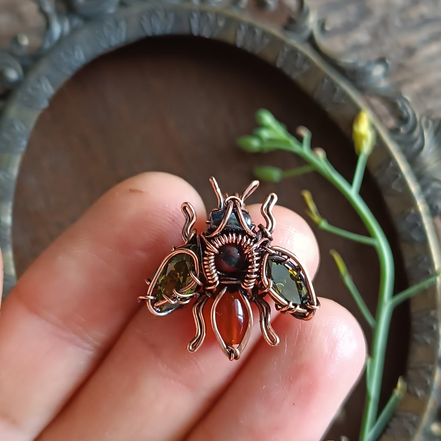 Green olive wings bee charm.
