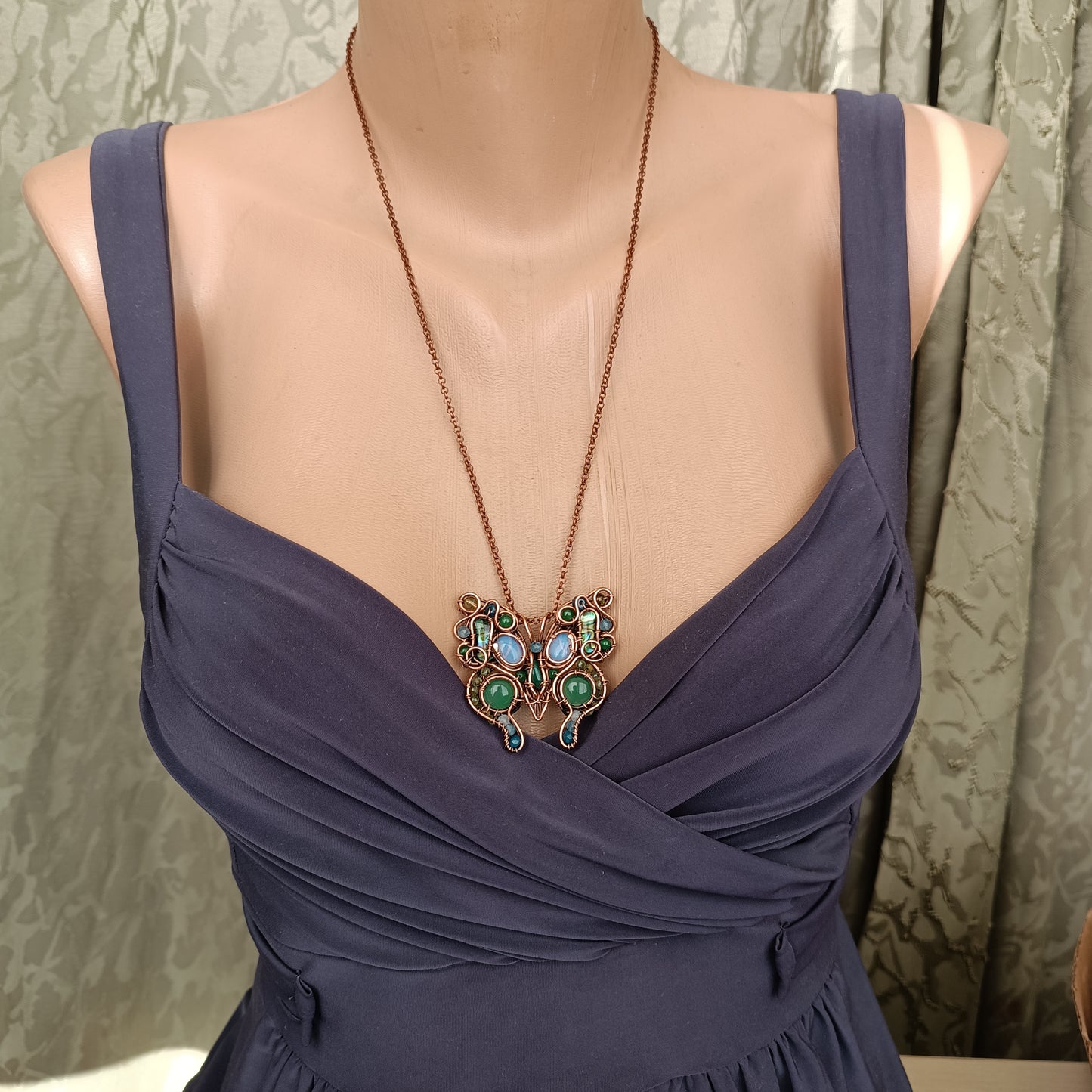 Green ice butterfly necklace.