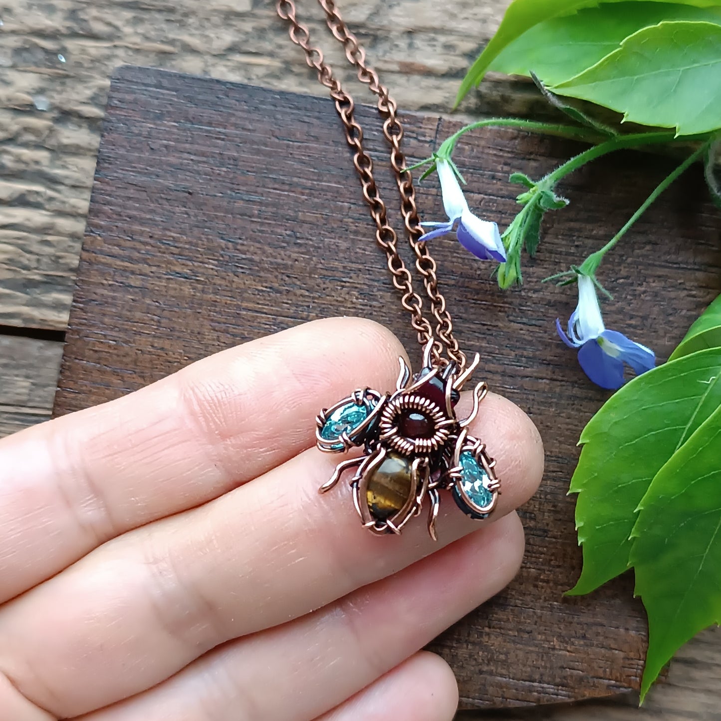 Tiny blue sparkle wings bee charm.