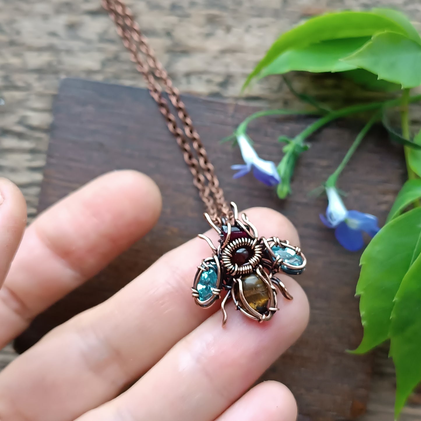 Tiny blue sparkle wings bee charm.