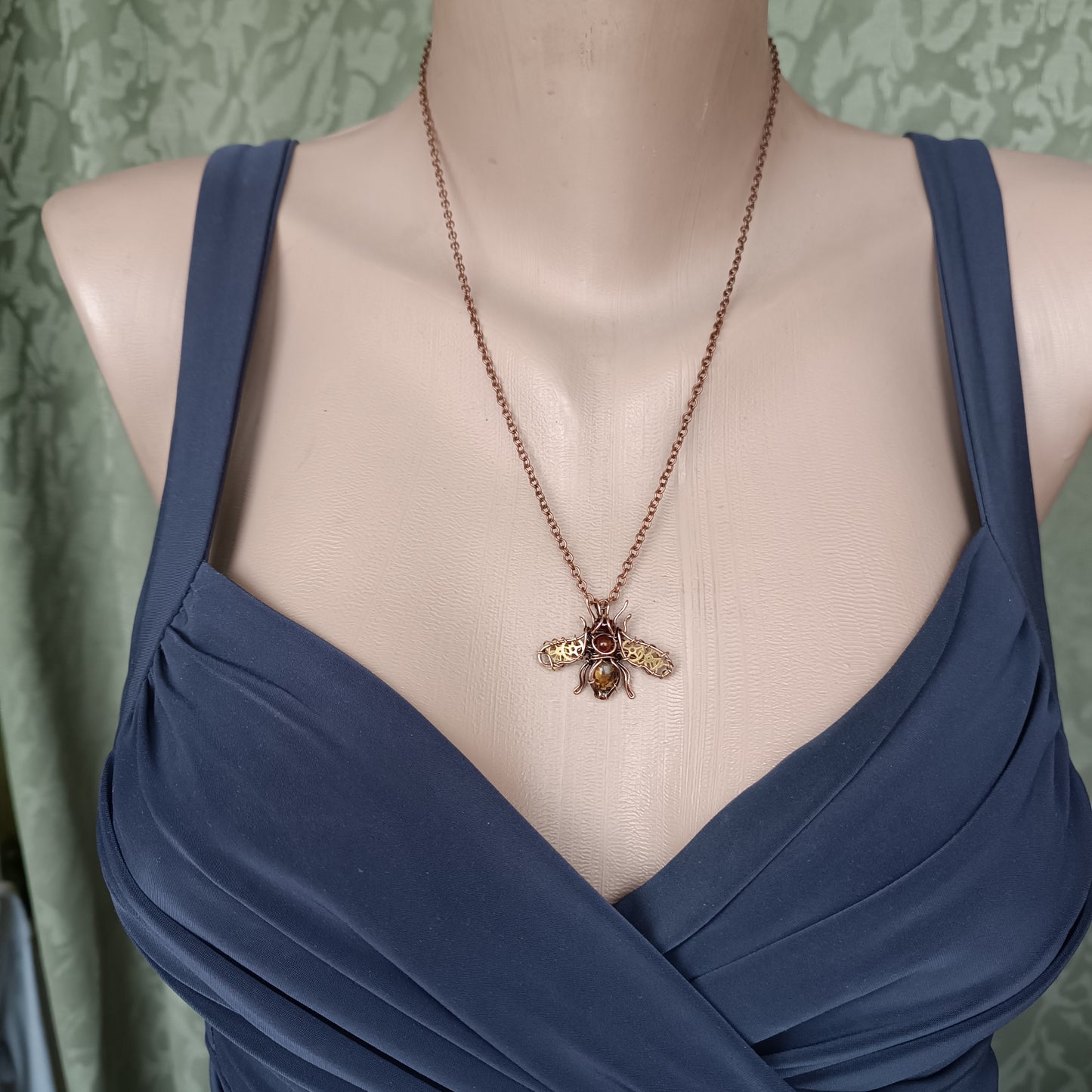Small golden cogs wings bee charm.