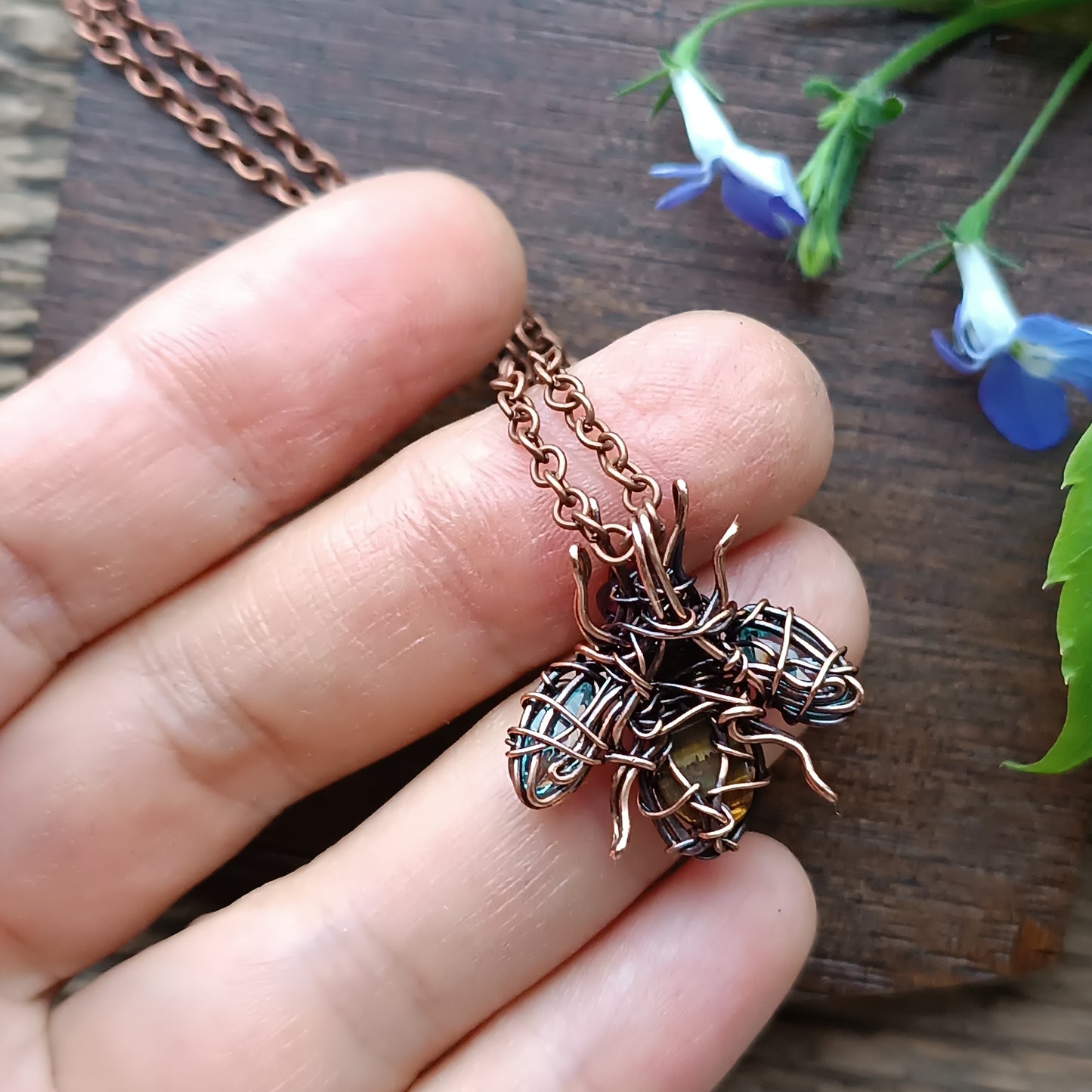 Tiny blue sparkle wings bee charm.