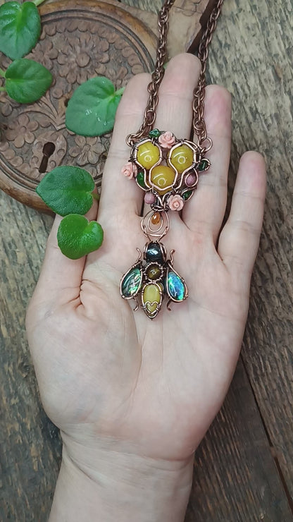 Honey bee pollinating in the rose garden. Necklace.