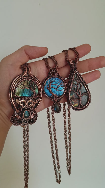 Three tree of life necklaces.