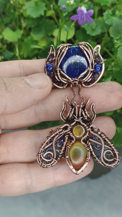Blue winged bee pollinating on a flower. Pin/pendant.