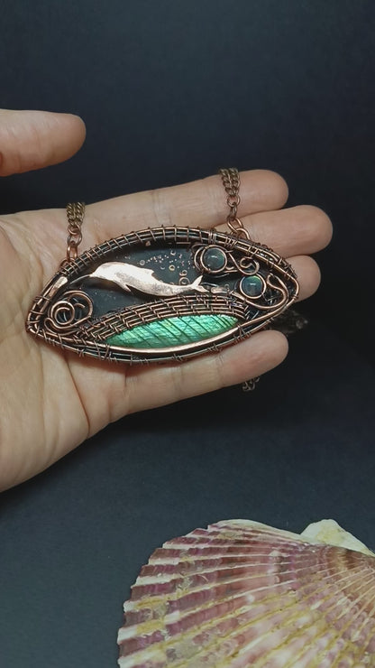 Dolphin playing in the ocean. Wire wrapped copper necklace.