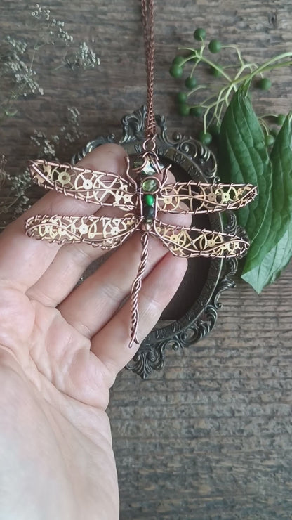 Large green dragonfly with golden cogs.