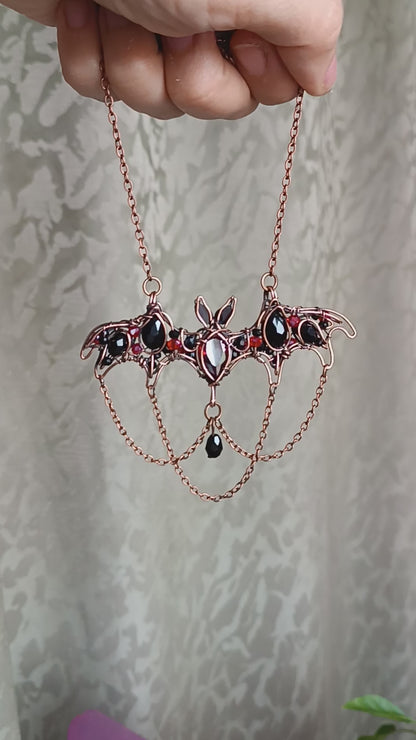 Scarlet dance. Bat necklace.