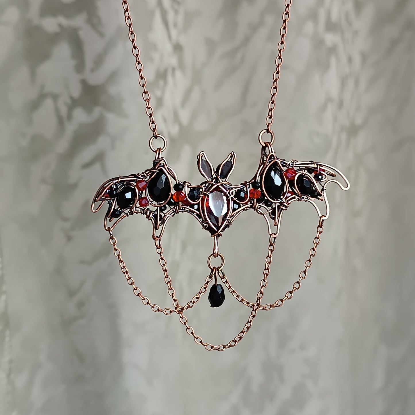 Scarlet dance. Bat necklace.
