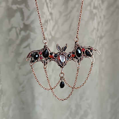 Scarlet dance. Bat necklace.