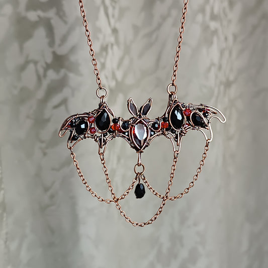 Scarlet dance. Bat necklace.
