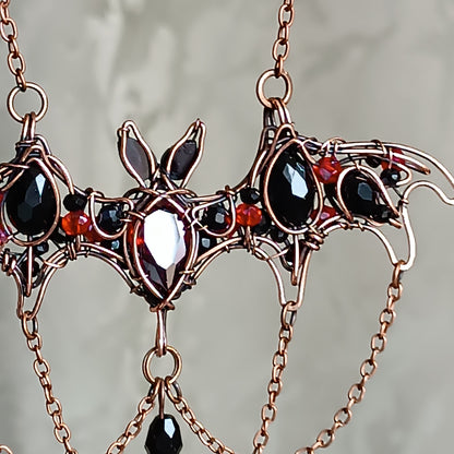 Scarlet dance. Bat necklace.
