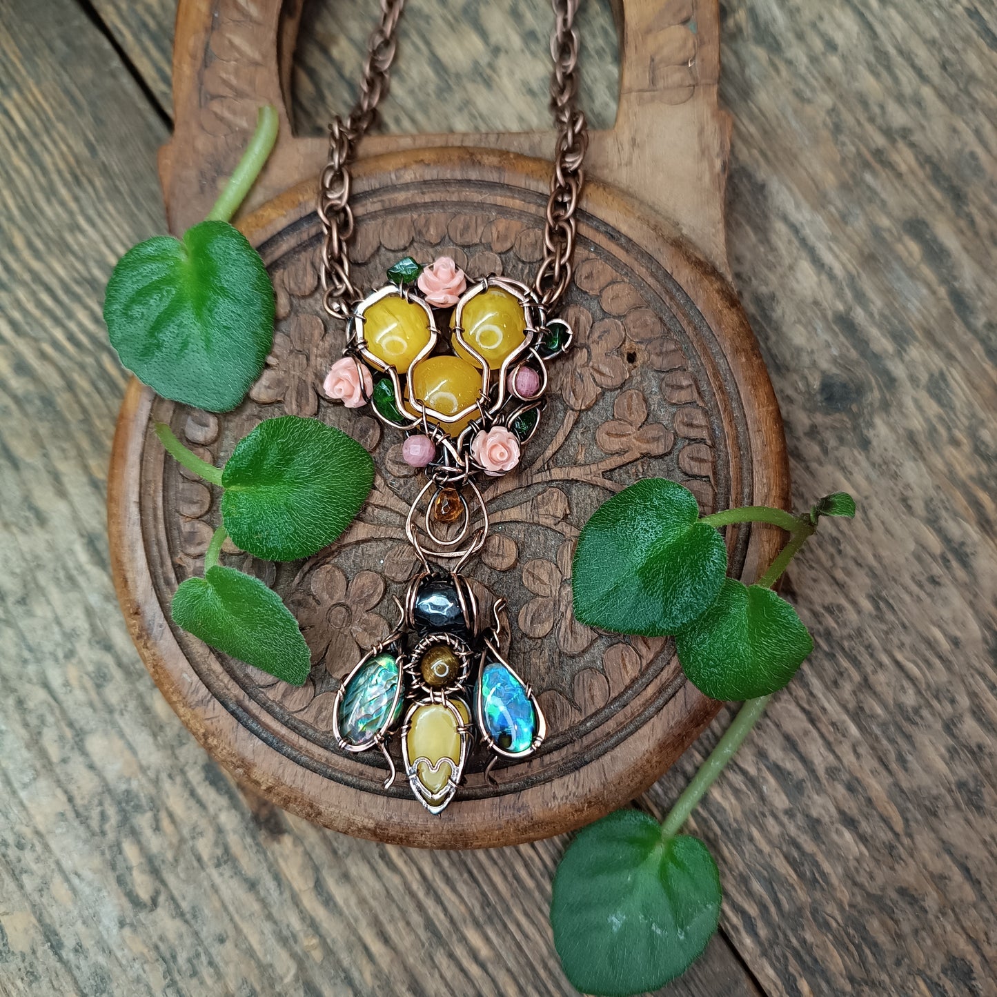Honey bee pollinating in the rose garden. Necklace.