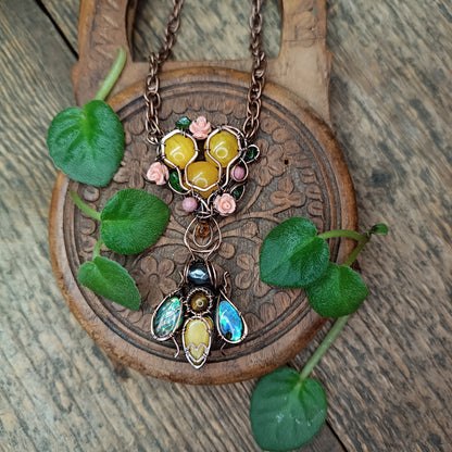Honey bee pollinating in the rose garden. Necklace.