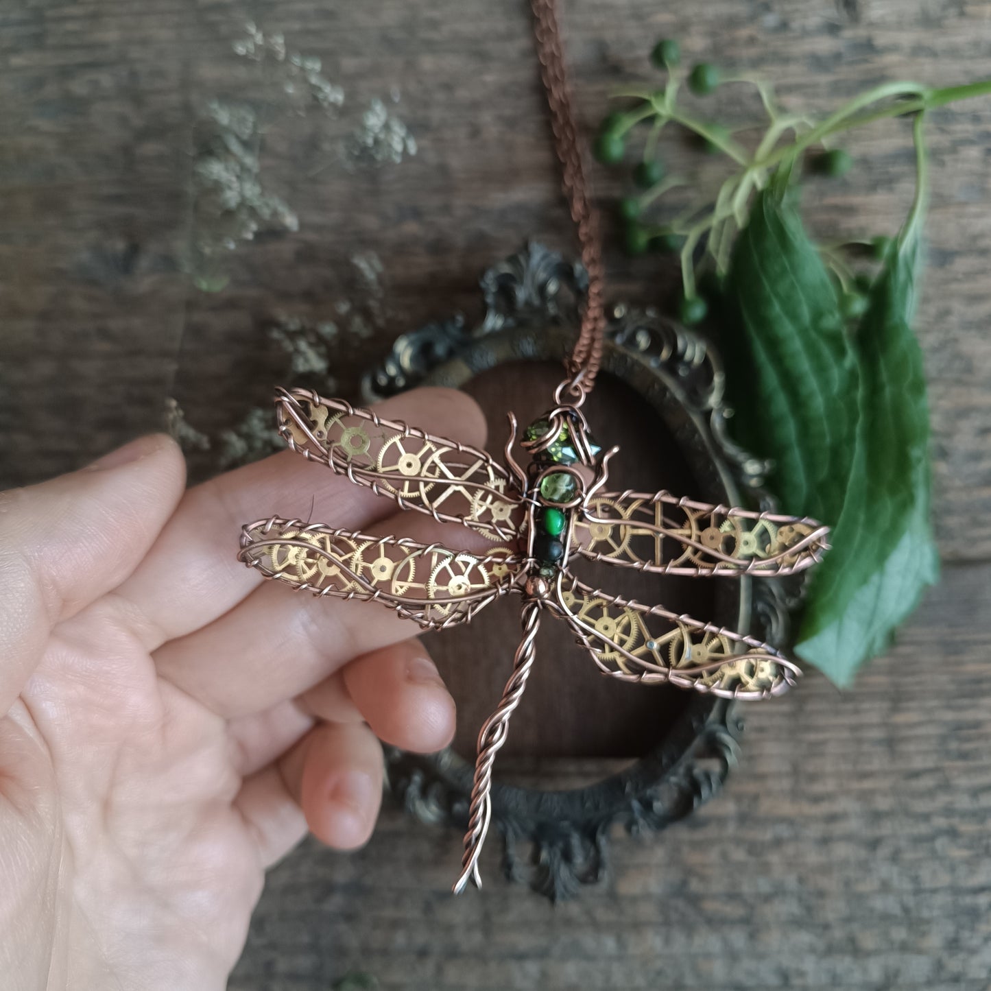 Large green dragonfly with golden cogs.