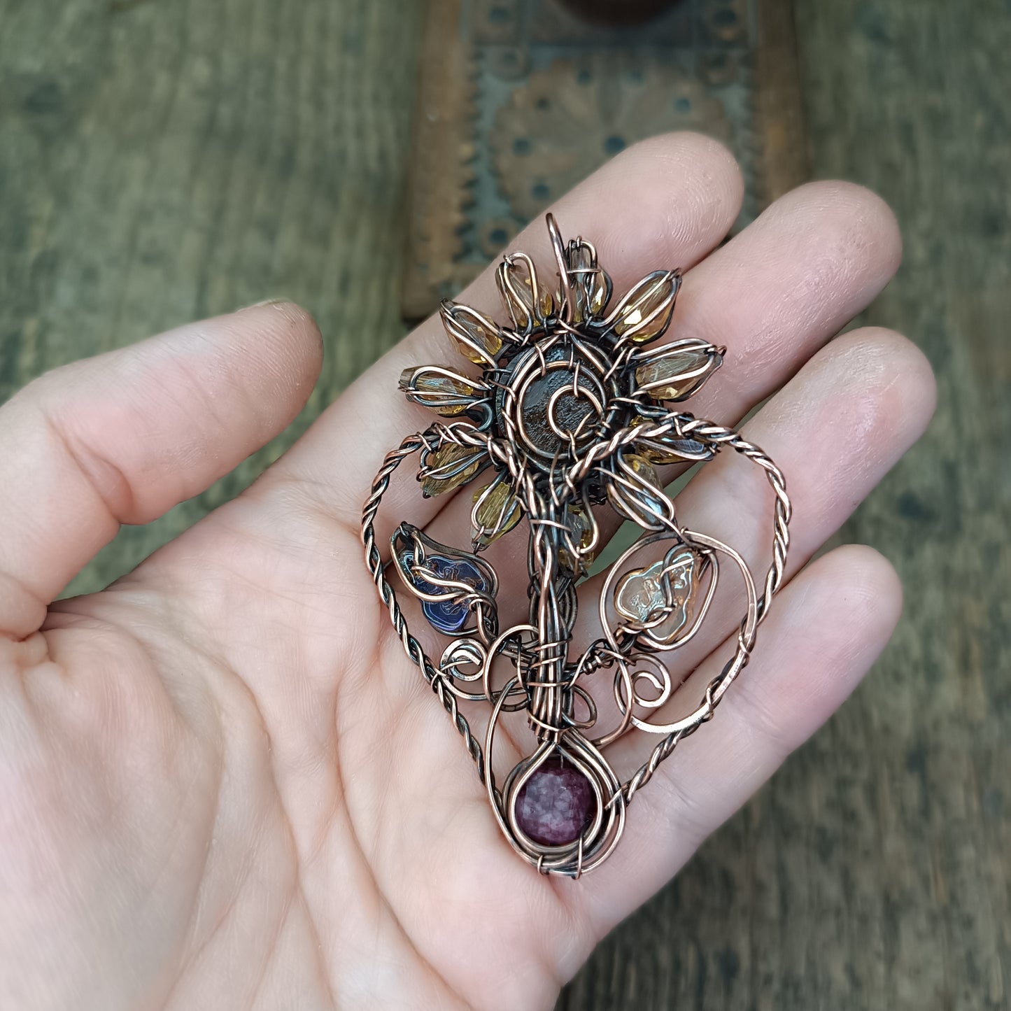 Sunflower pendant with garnet root