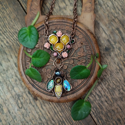 Honey bee pollinating in the rose garden. Necklace.