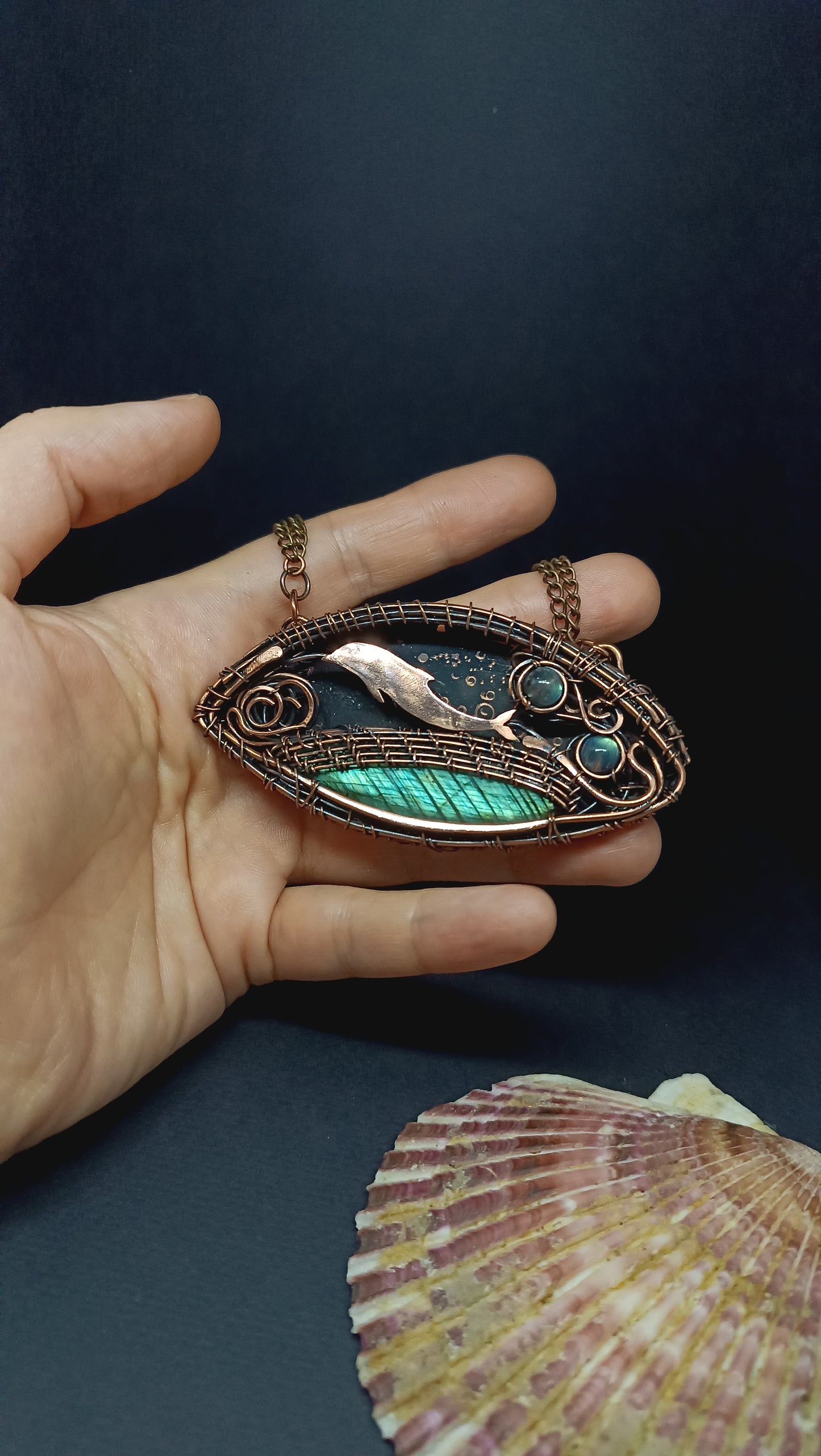 Dolphin playing in the ocean. Wire wrapped copper necklace.