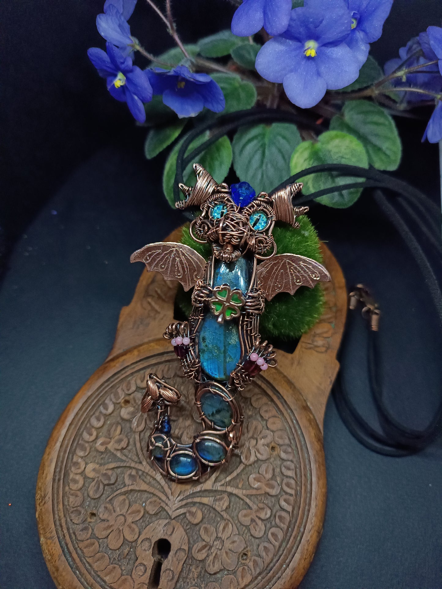 Blue baby dragon with shamrock necklace.