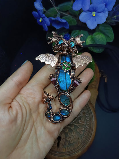 Blue baby dragon with shamrock necklace.