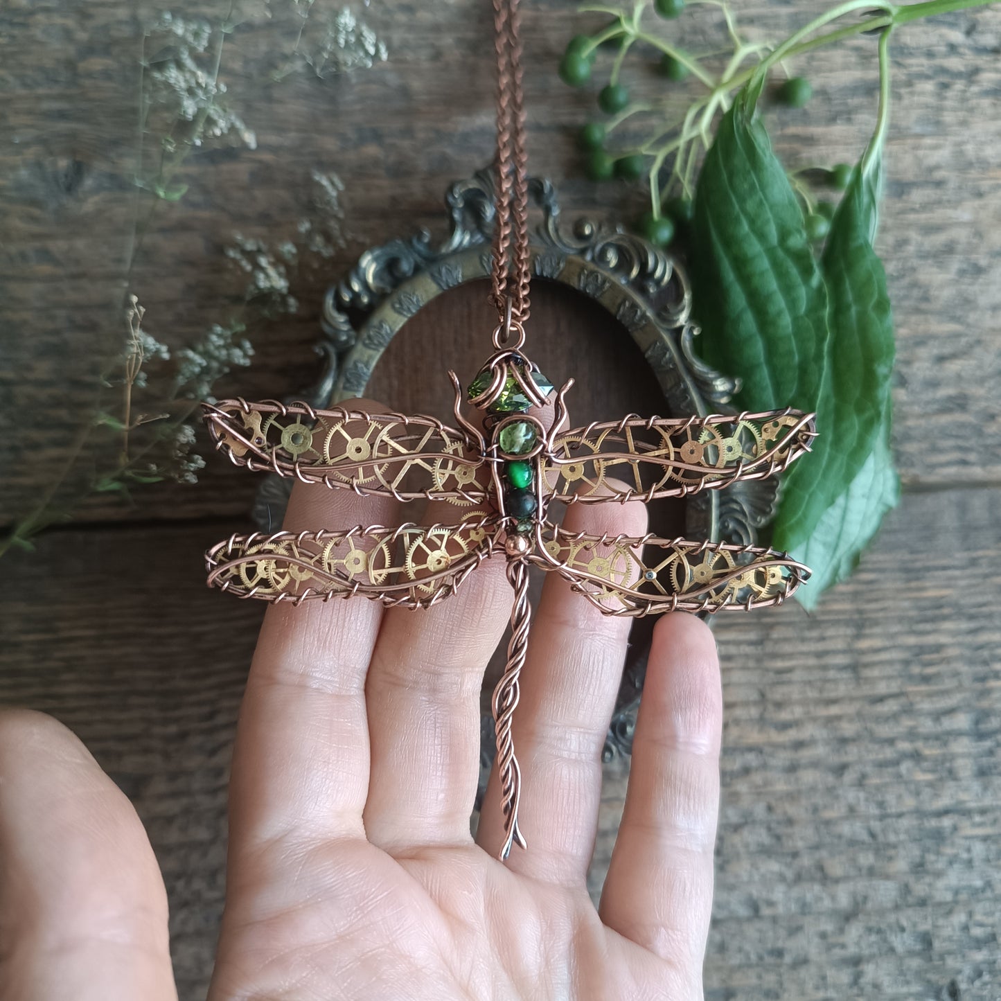 Large green dragonfly with golden cogs.