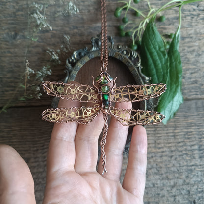 Large green dragonfly with golden cogs.