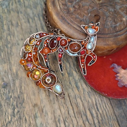 Swoopy tail Foxy. Sparkly wire wrapped pendant.