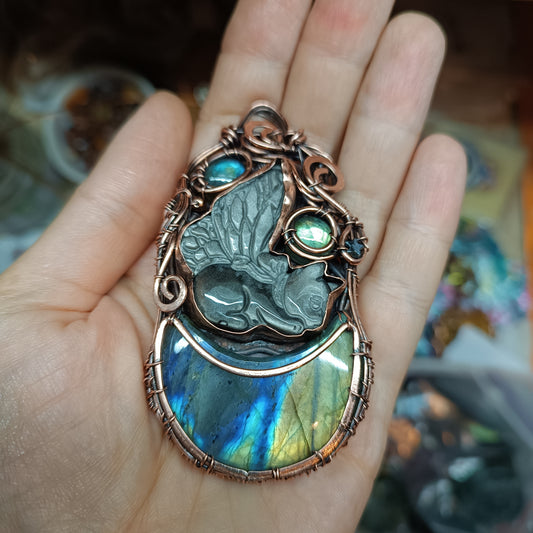 Winged kitty sleeping on the moon