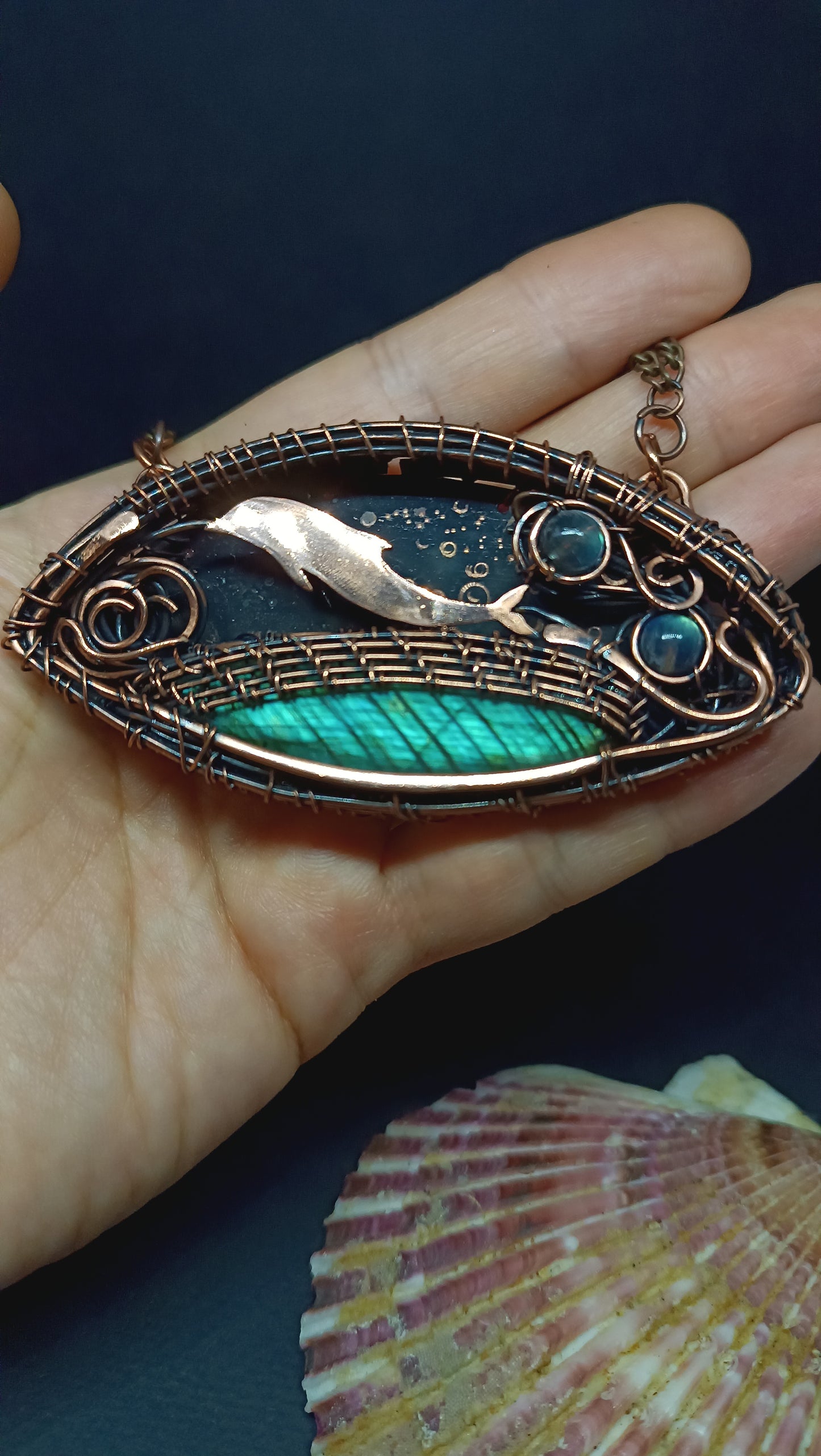 Dolphin playing in the ocean. Wire wrapped copper necklace.