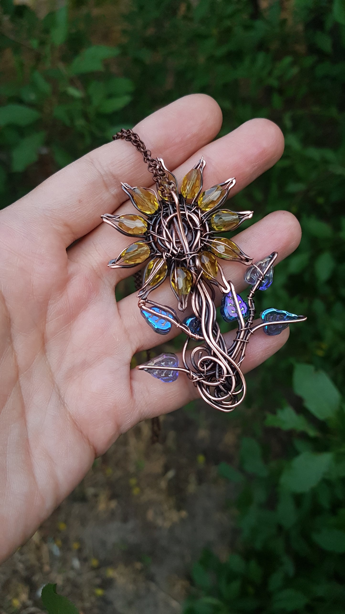 Sunflower pendant with blue leaves