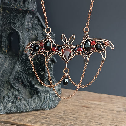 Scarlet dance. Bat necklace.