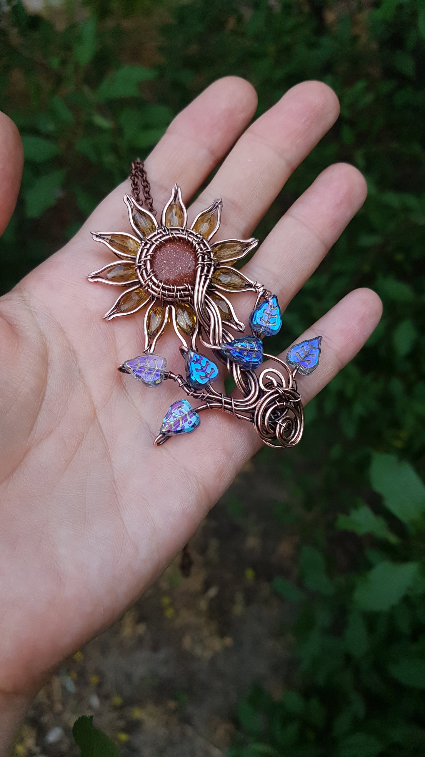 Sunflower pendant with blue leaves