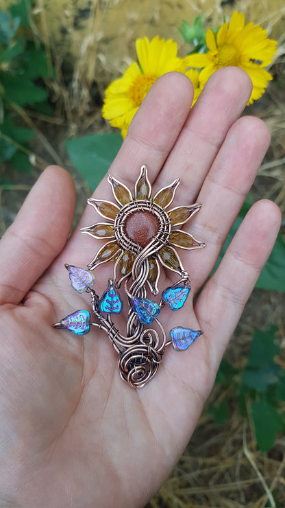 Sunflower pendant with blue leaves