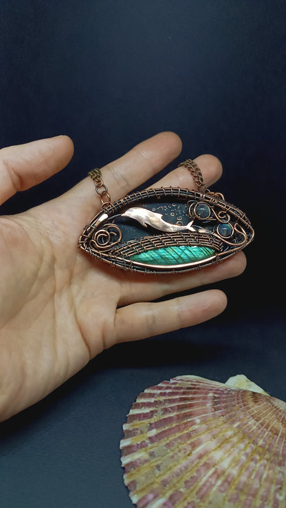 Dolphin playing in the ocean. Wire wrapped copper necklace.