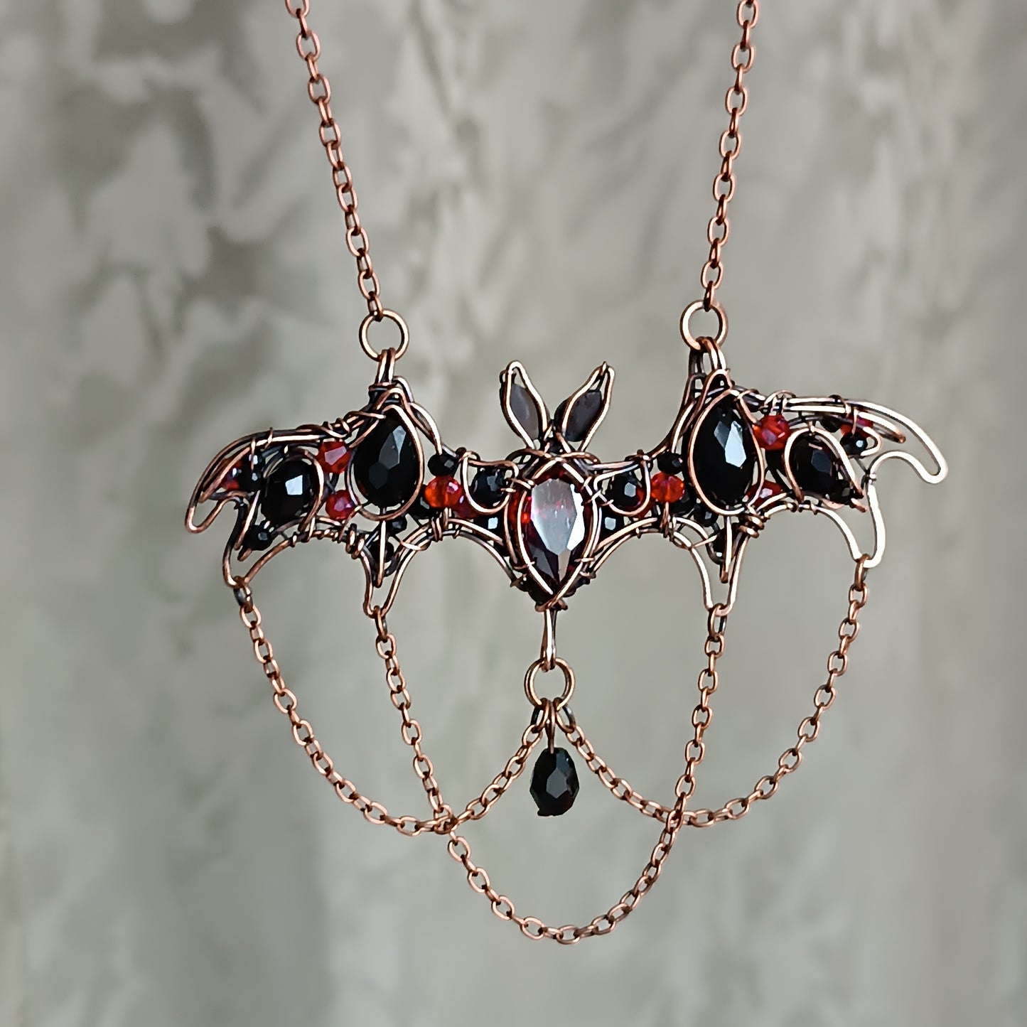 Scarlet dance. Bat necklace.