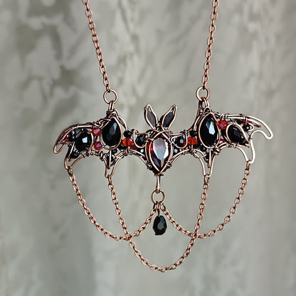 Scarlet dance. Bat necklace.