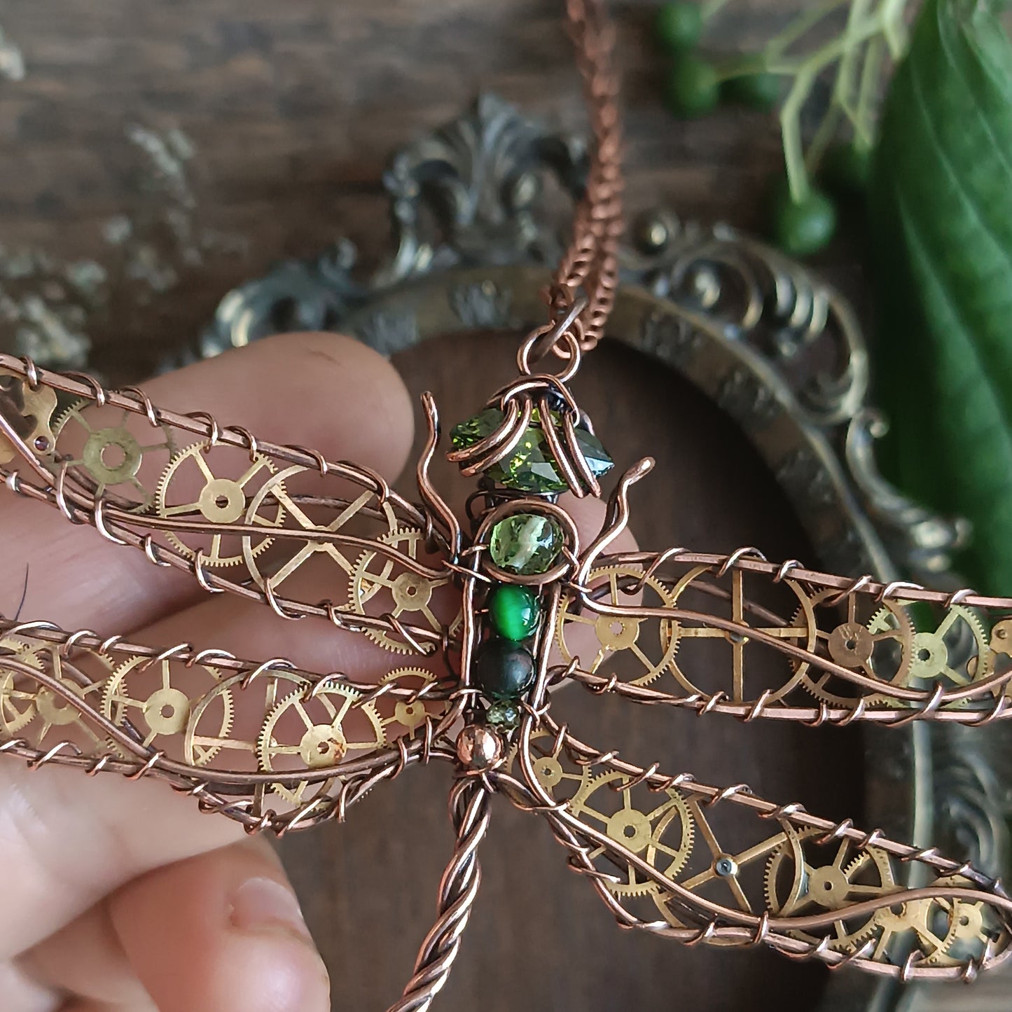 Large green dragonfly with golden cogs.