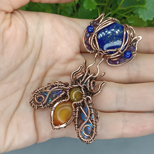 Blue winged bee pollinating on a flower. Pin/pendant.