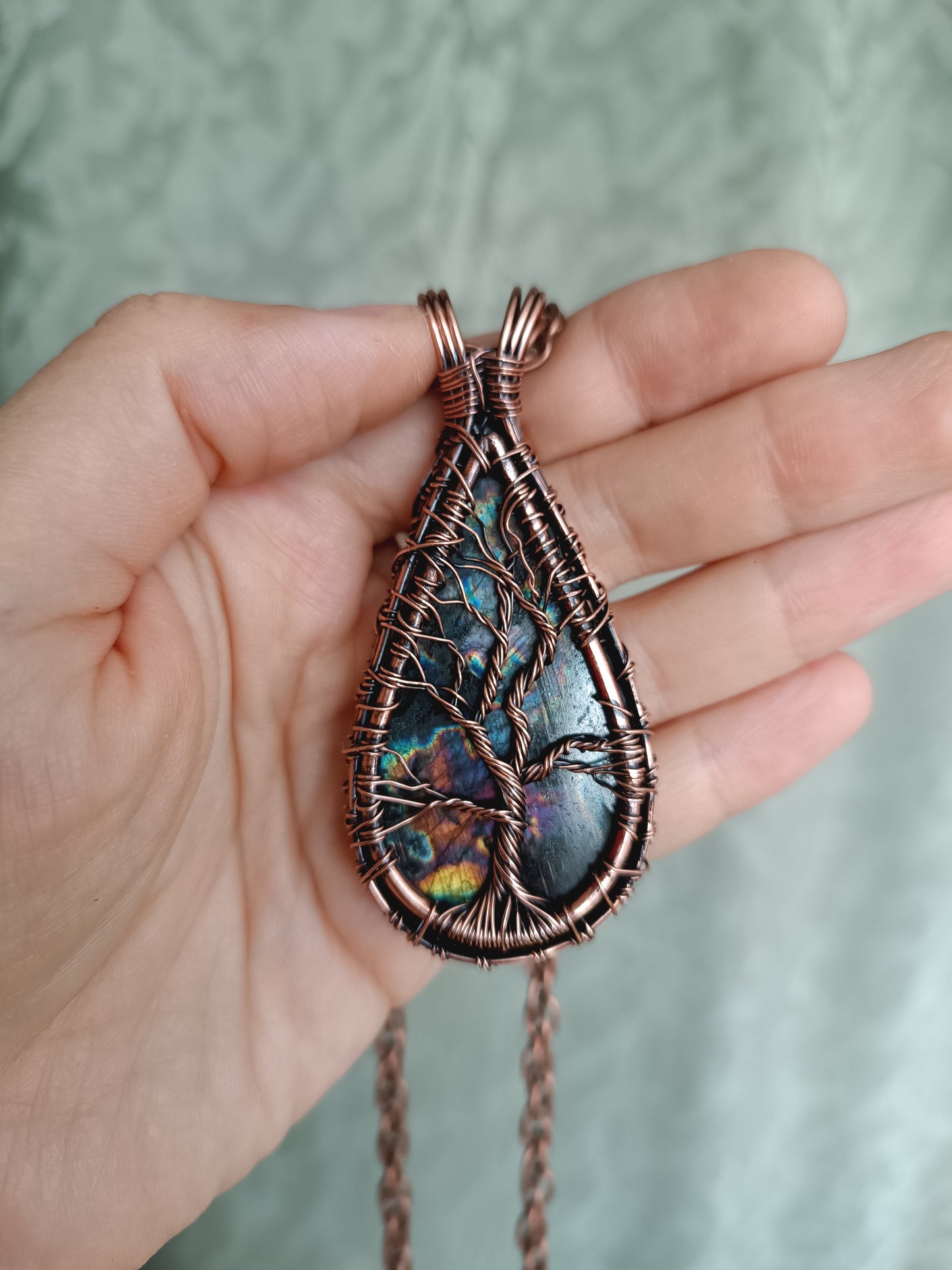 Three tree of life necklaces.