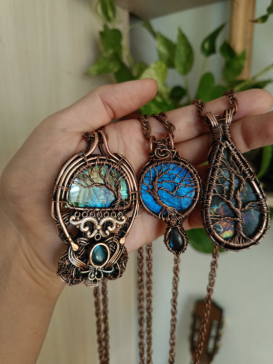 Three tree of life necklaces.