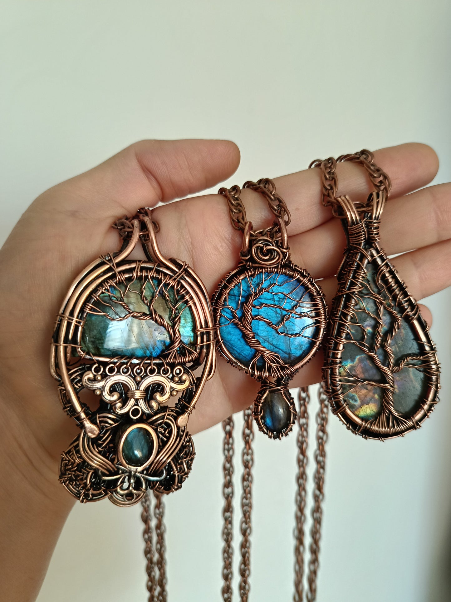 Three tree of life necklaces.