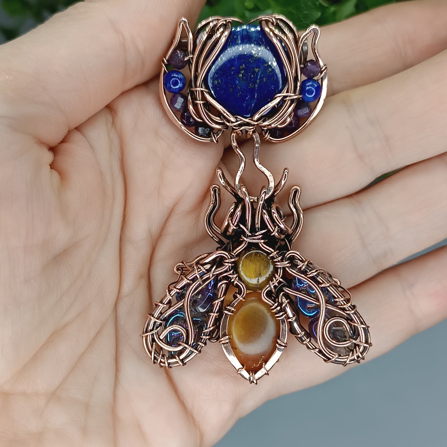 Blue winged bee pollinating on a flower. Pin/pendant.