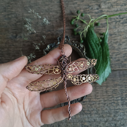 Large green dragonfly with golden cogs.