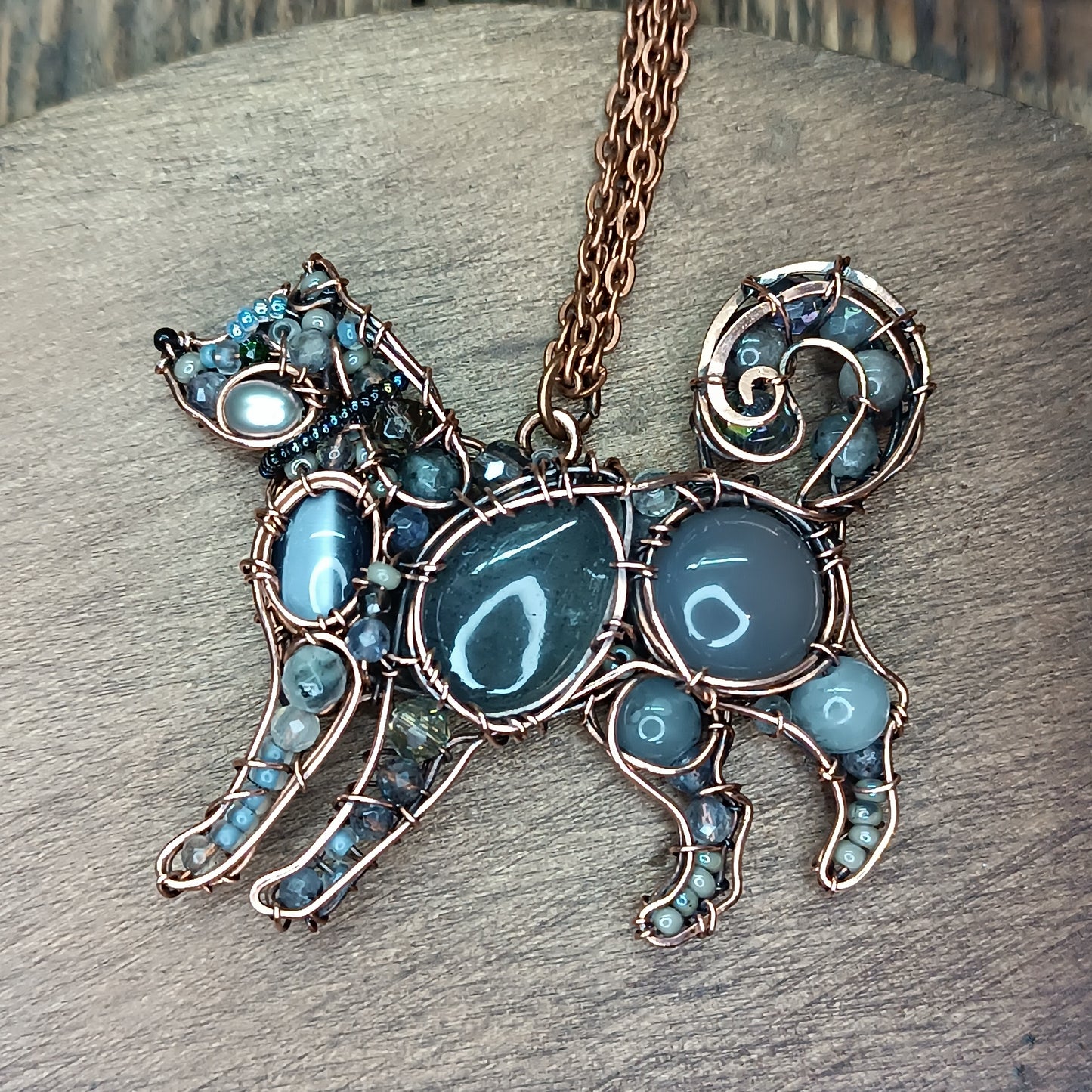 Sweet puppy. Detailed wire wrapped and beaded pendant.