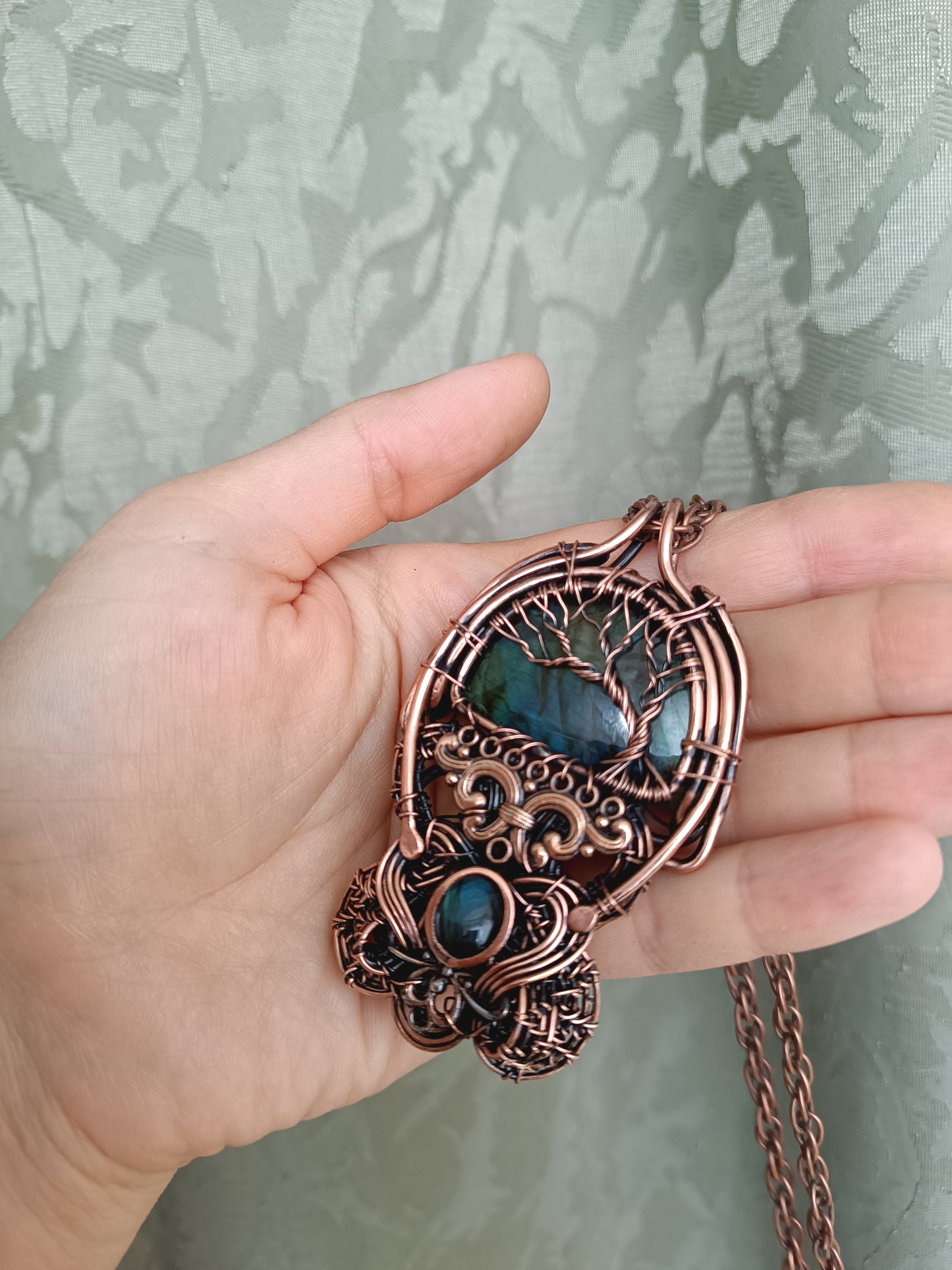 Three tree of life necklaces.